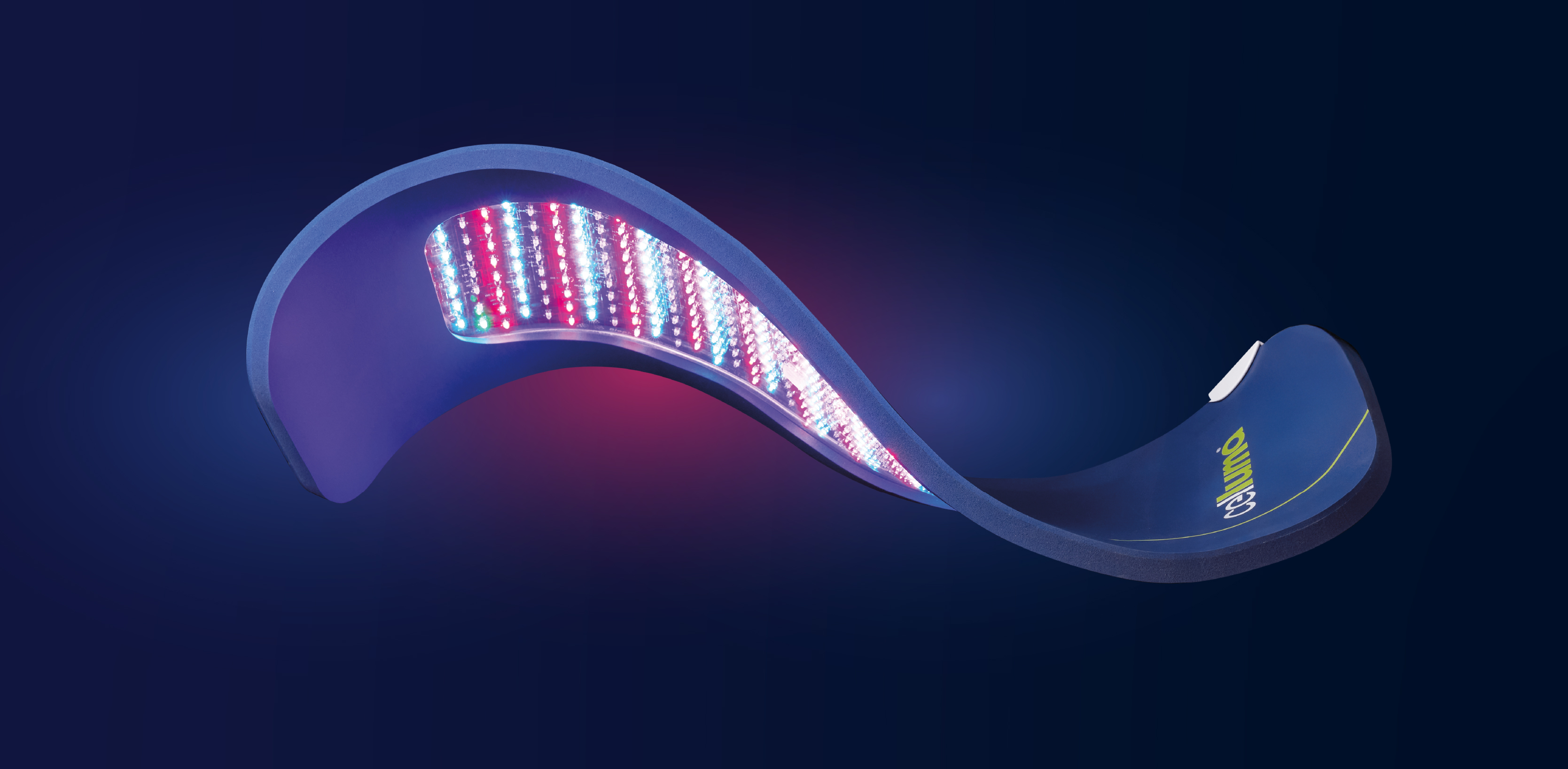 Image of a floating Celluma PRO LED light therapy panel on a dark background, showing the underside lit with red light, blue light, and near-infrared light.