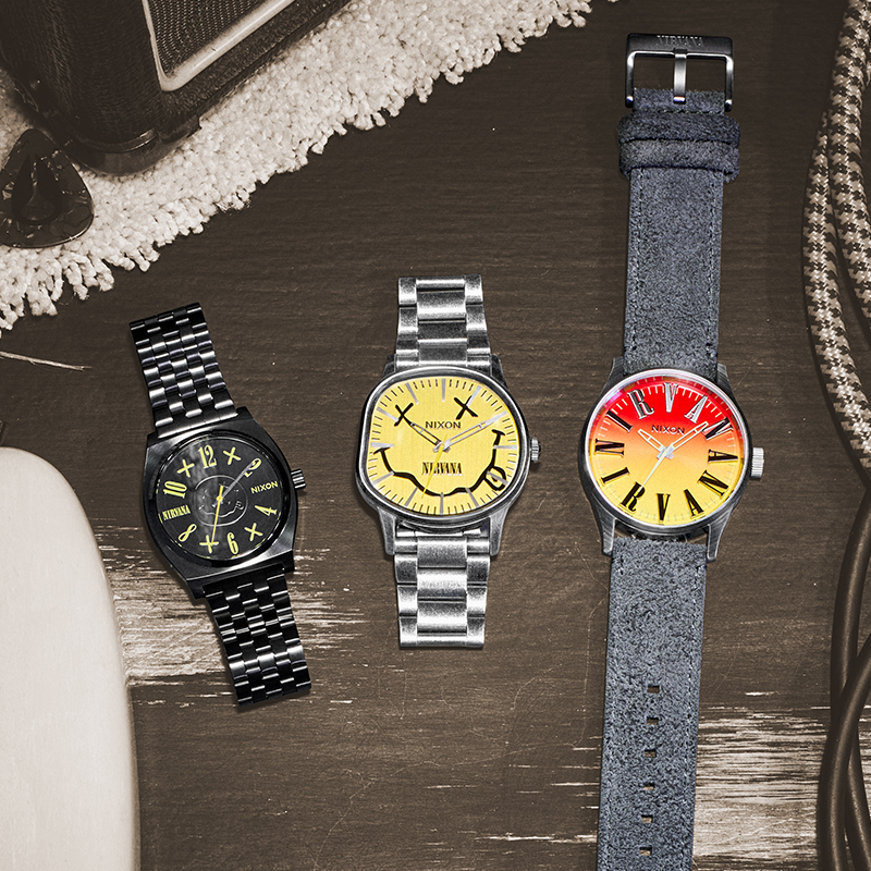 lay down of three watches from the Nirvana x Nixon collaboration on top of an old carpet in a recording studio.