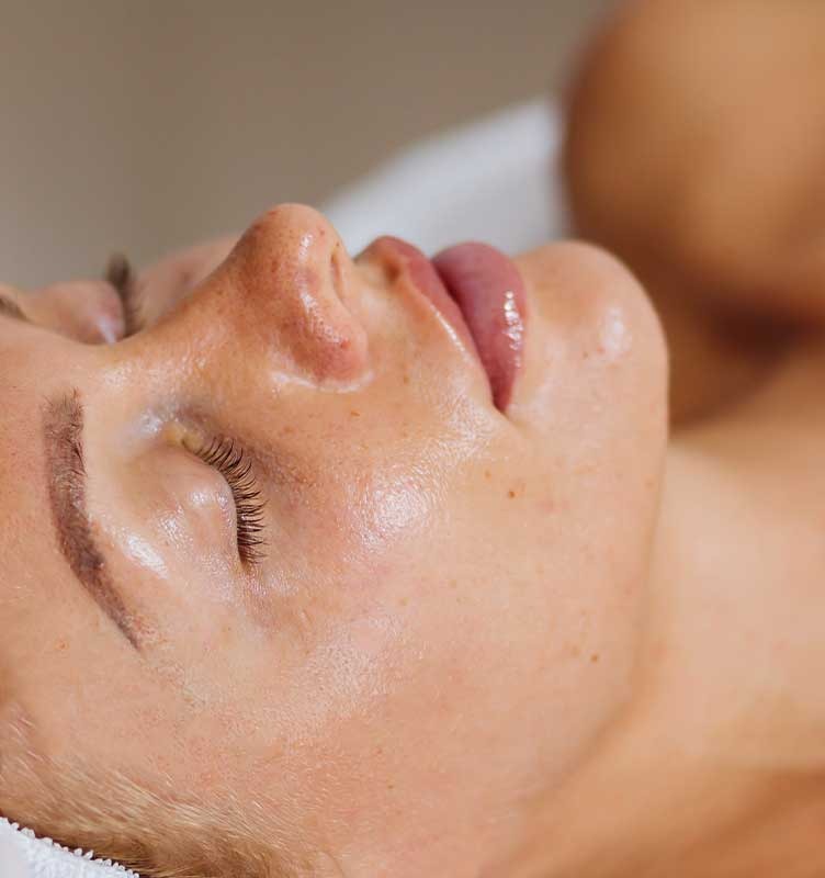 Woman receiving a professional skin treatment in salon