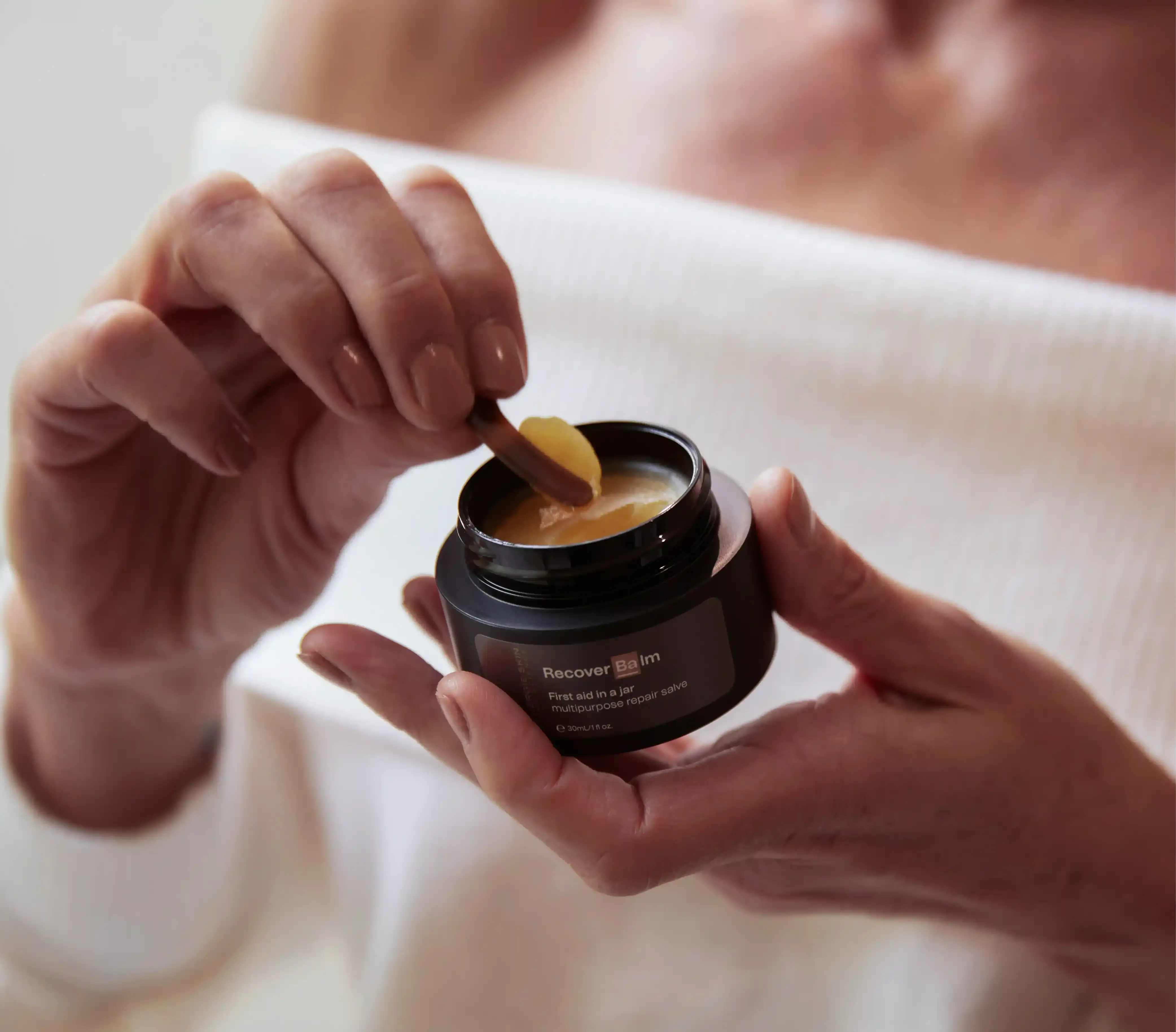 Model demonstrating Synergie Skin Recover Balm