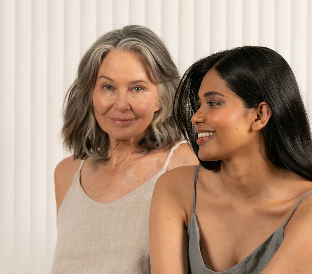 Middle aged woman and young woman sitting next to each other