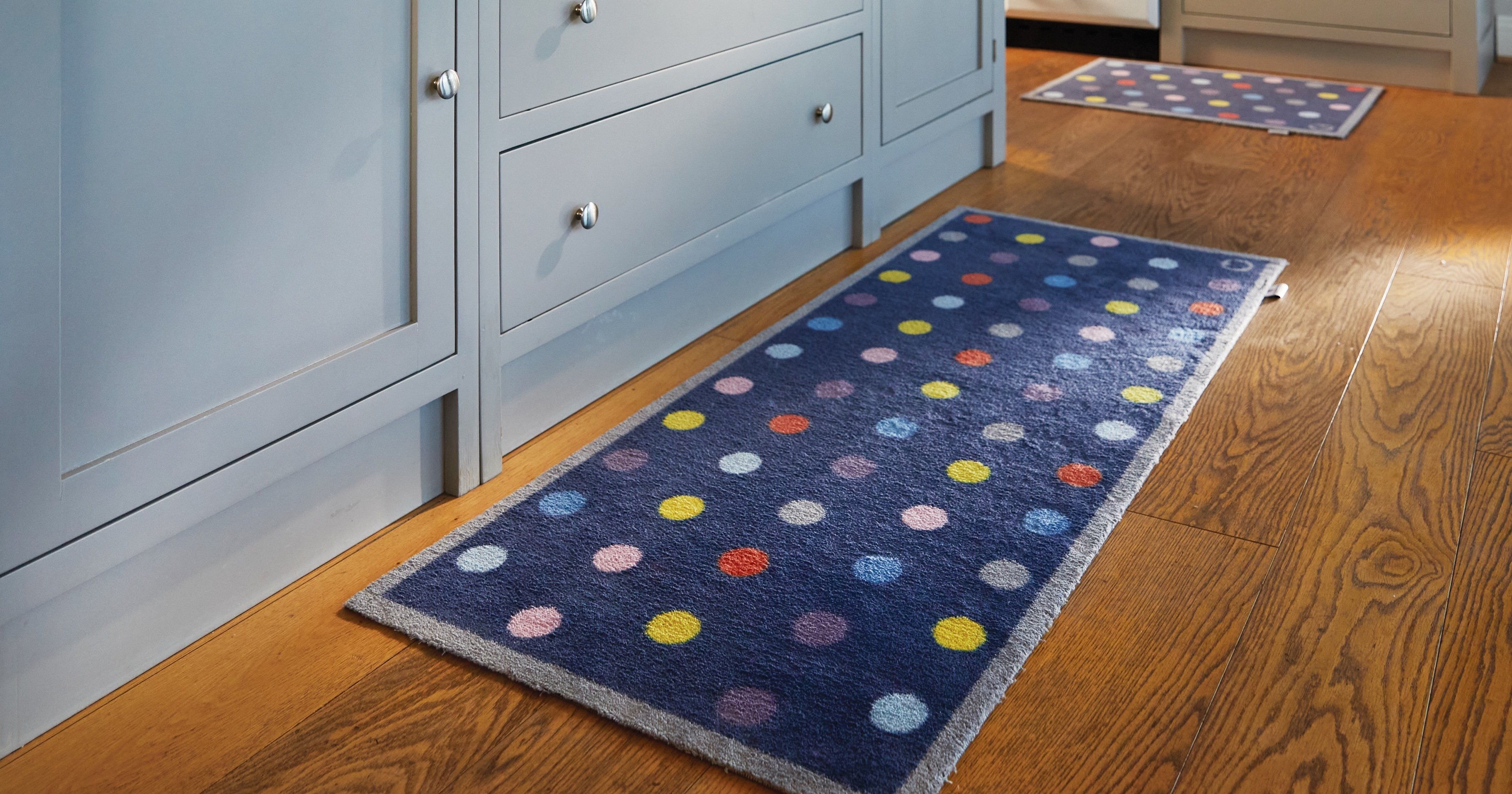 A bright spotted kitchen runner on a kitchen floor