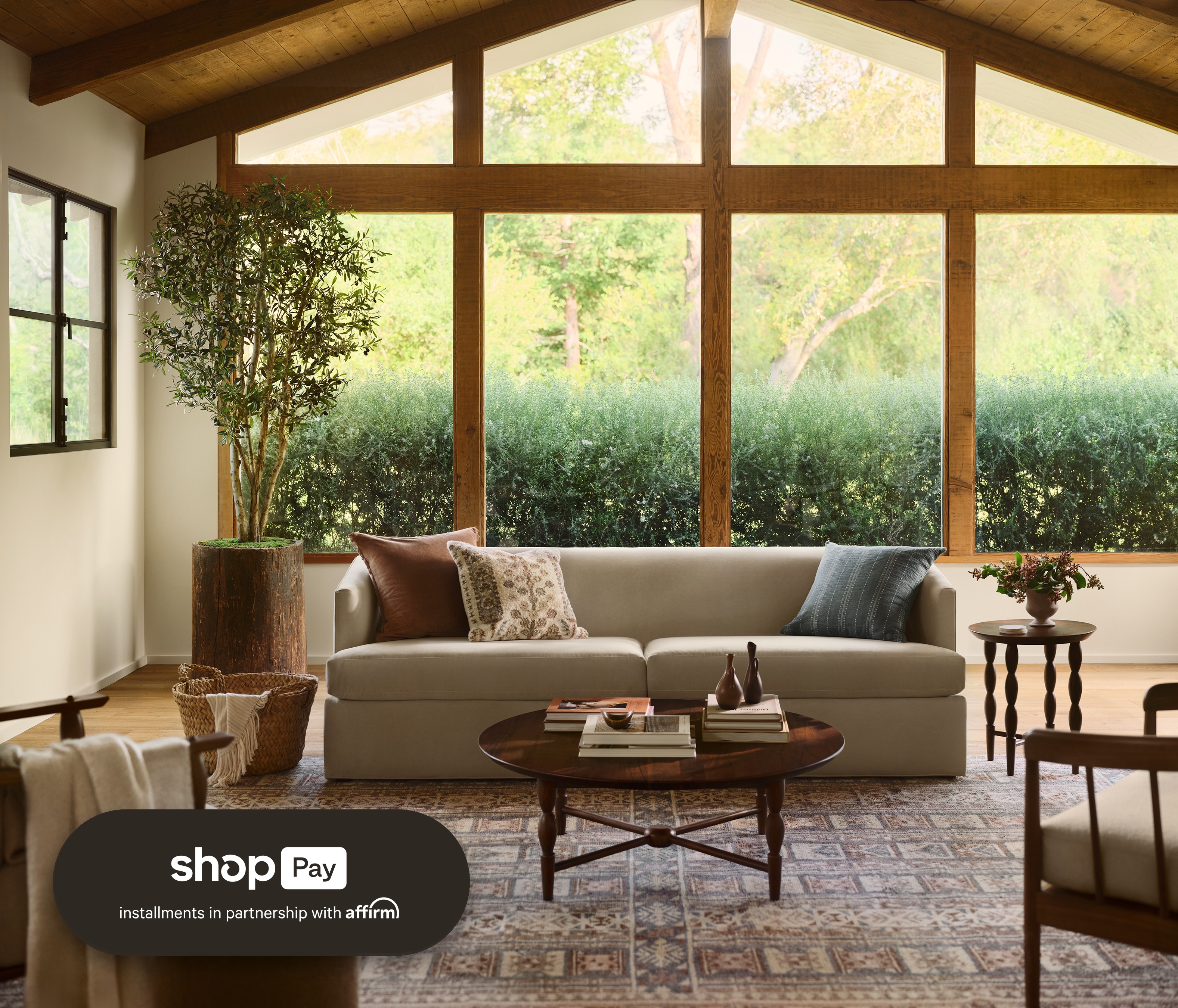 Sunlit living room with a linen sofa and layered area rug, styled with Shop Pay Installments payment options at The Citizenry