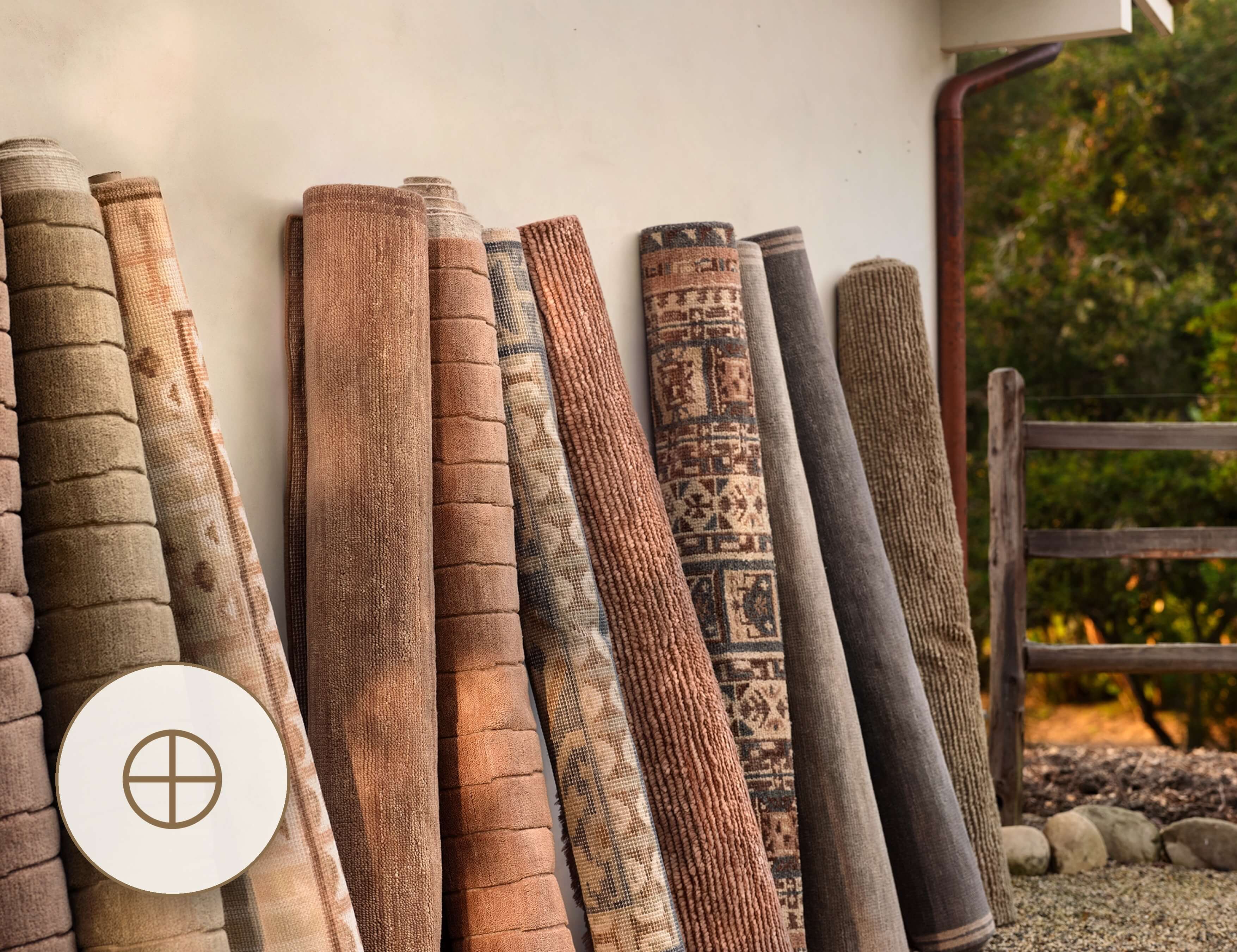 Rolled area rugs in warm earth tones displayed side by side at The Citizenry