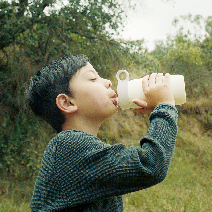  Little boy drinking out of the white PLAY tumbler  