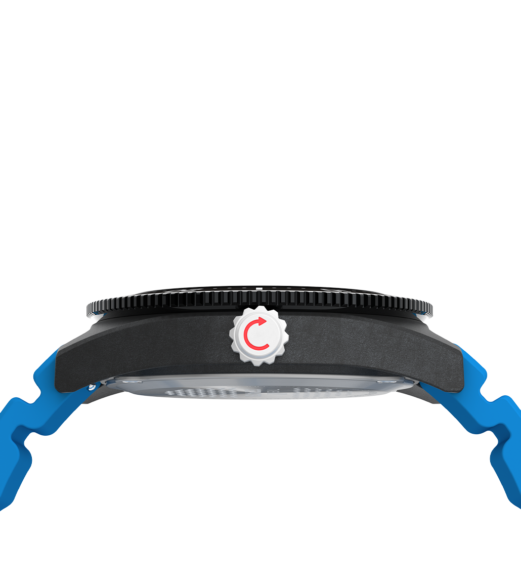 Side profile of the Timex Deepwater 200M watch highlighting the rugged black case, silver screw-down crown with red circular arrow detail, and blue silicone straps extending from the lugs. The steel bezel edge and caseback are partially visible.