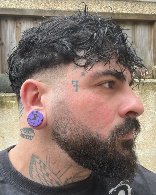Girl wearing goth Marble Black & Purple Stone Plug / Gauge