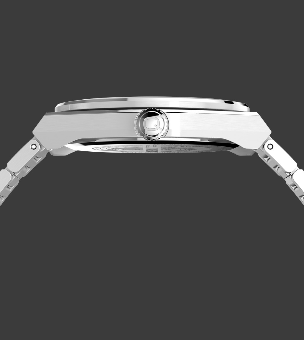 Side profile of the Q Timex® Continental GMT watch highlighting its slim case design, engraved crown with Q logo, and brushed stainless steel bracelet links against a dark grey background.