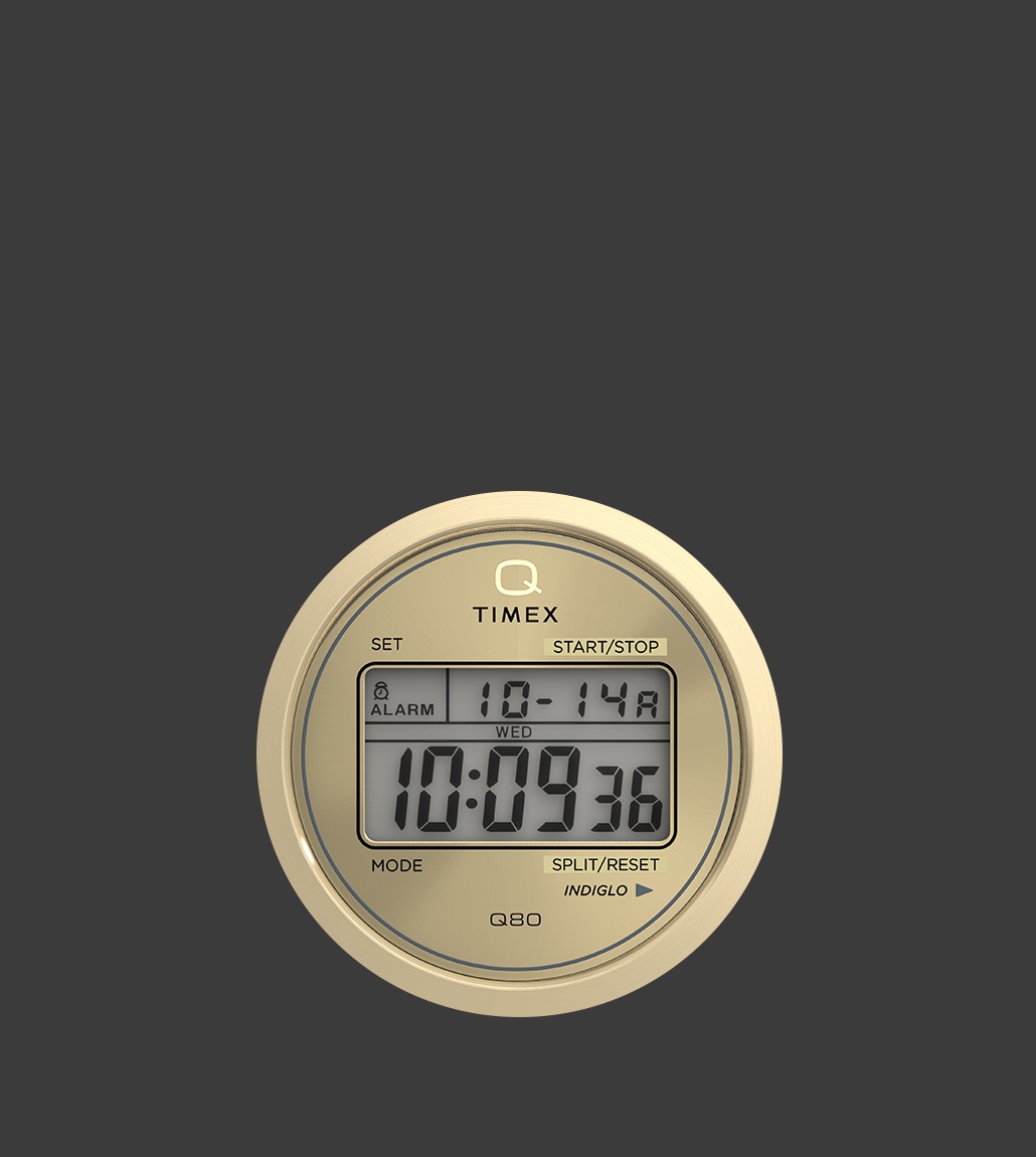 Close-up of the Q Timex® Q80 Continental’s digital dial, highlighting the INDIGLO® backlight feature, dual digital displays for time and date, and the clean circular layout in a gold-tone finish.