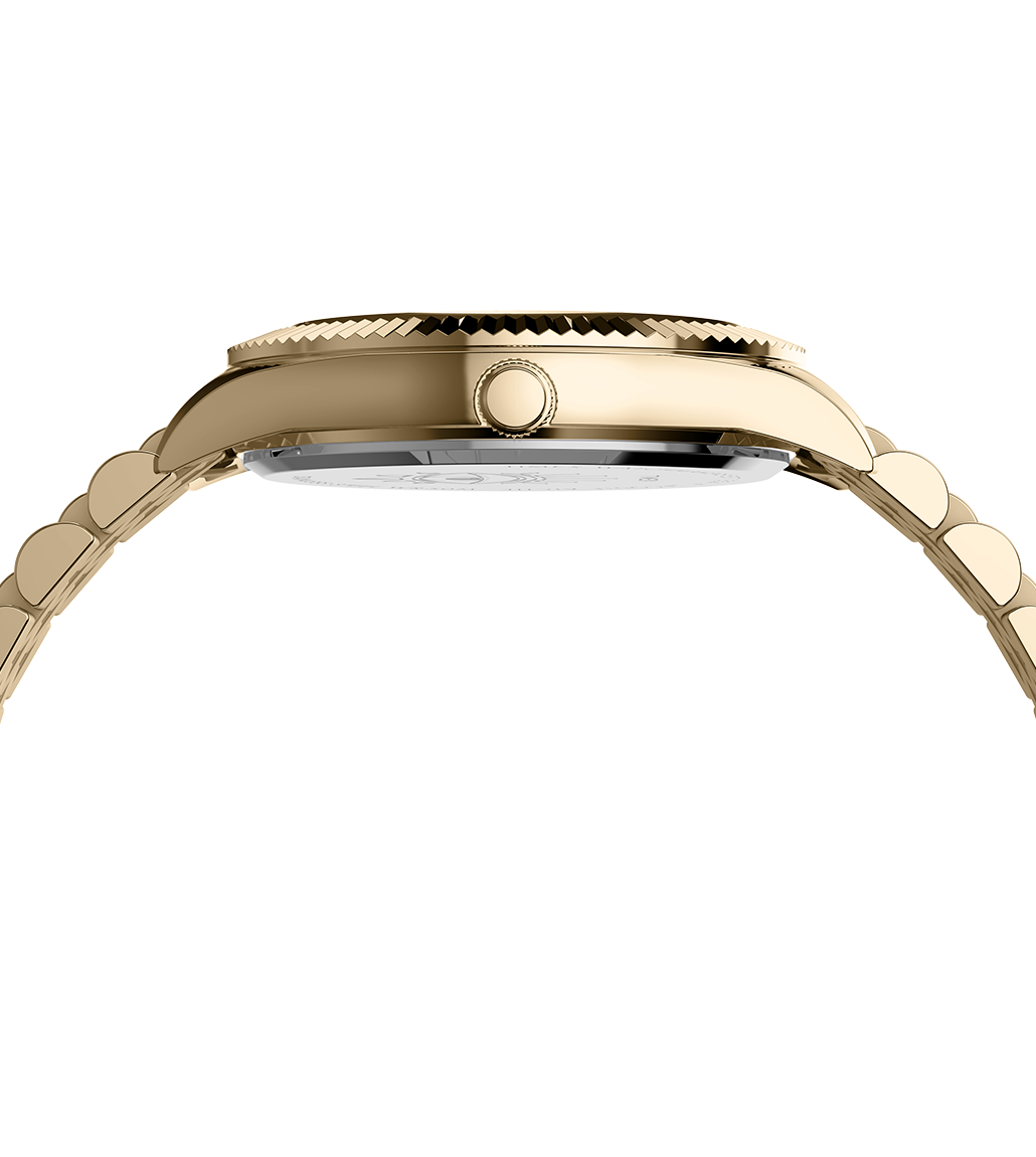 Side view of the Timex x Jacquie Aiche gold-tone wristwatch showing the polished case profile, crown detail, and curved bracelet links.