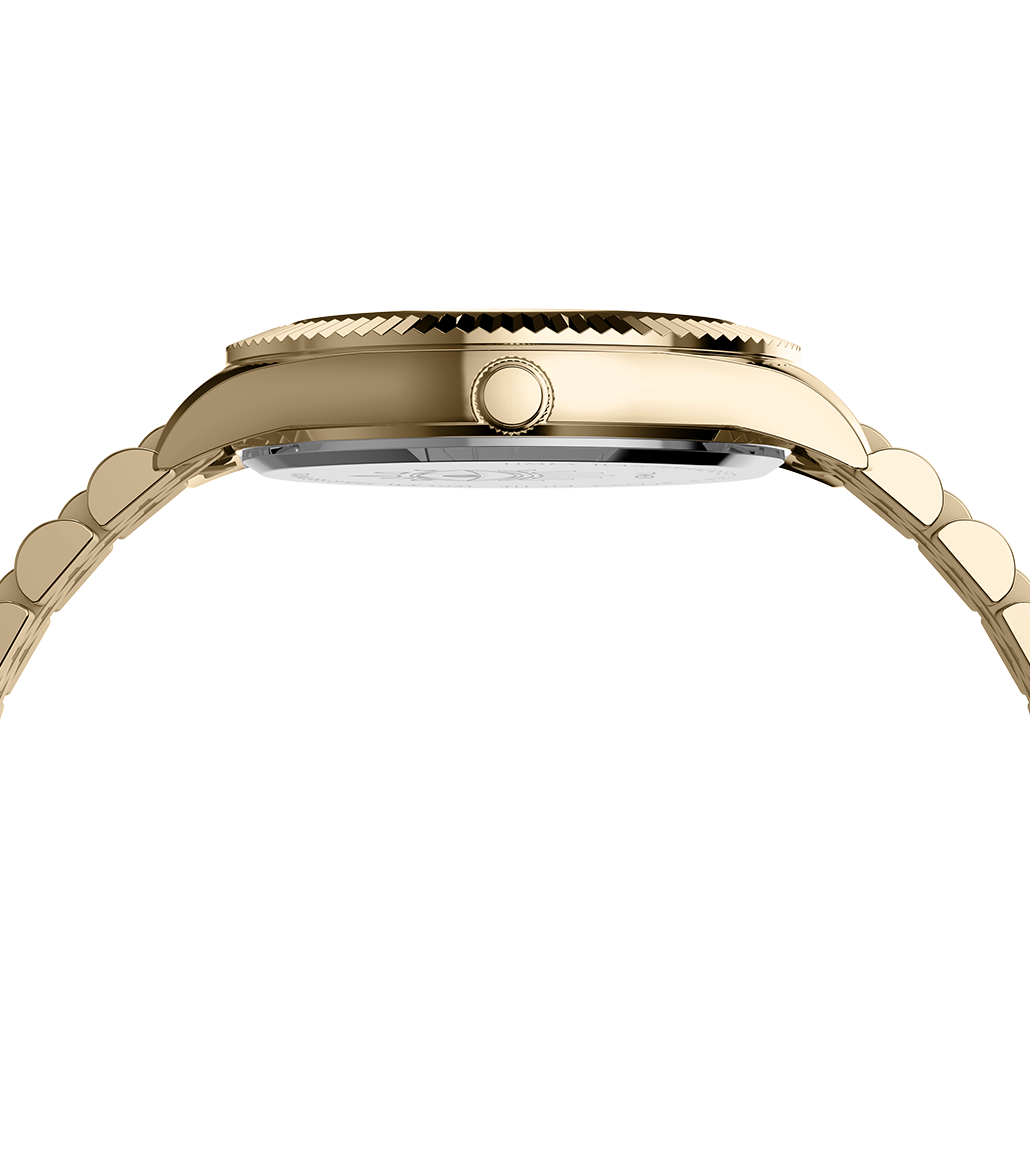 Side view of the Timex x Jacquie Aiche gold-tone wristwatch showing the polished case profile, crown detail, and curved bracelet links.