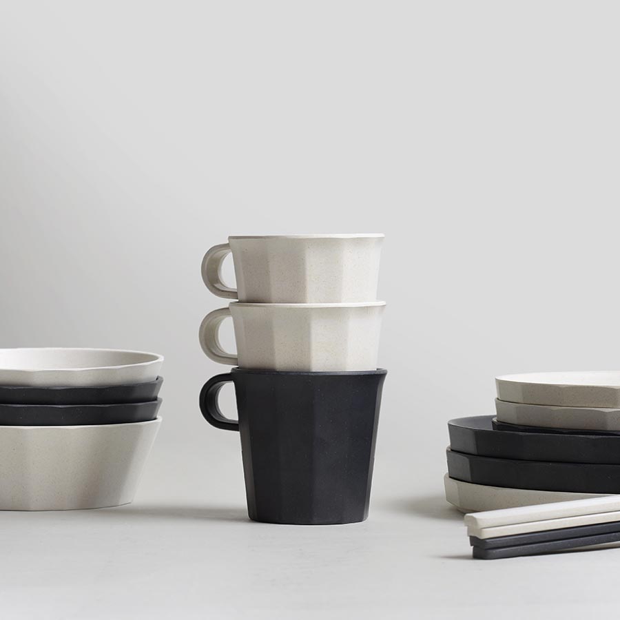  ALFRESCO bowls, plates, and mugs in black and white stacked  