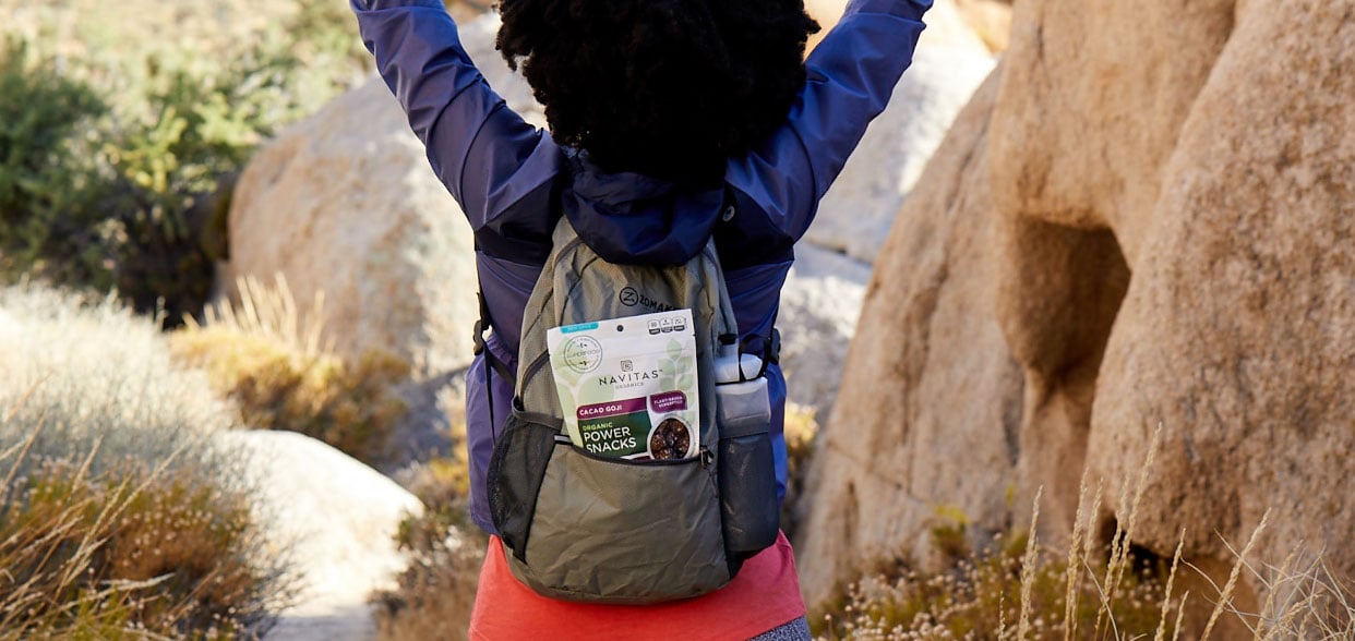 Backpack with package of Navitas Power Snacks Cacao Goji