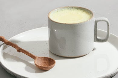Mug of latte made with Navitas Maca Powder 