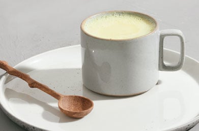 Mug of latte made with Navitas Maca Powder