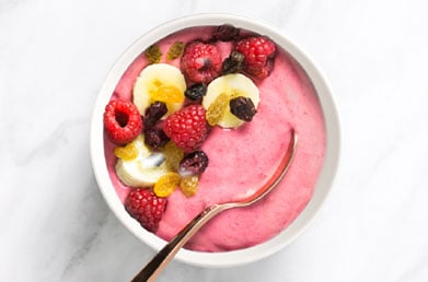 Bowl of yogurt made with Navitas Goji Powder and topped with fresh ingredients