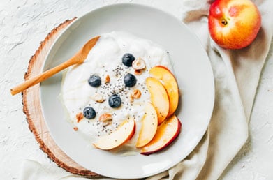 Bowl of yogurt with Navitas Chia Seed Powder and fresh ingredients