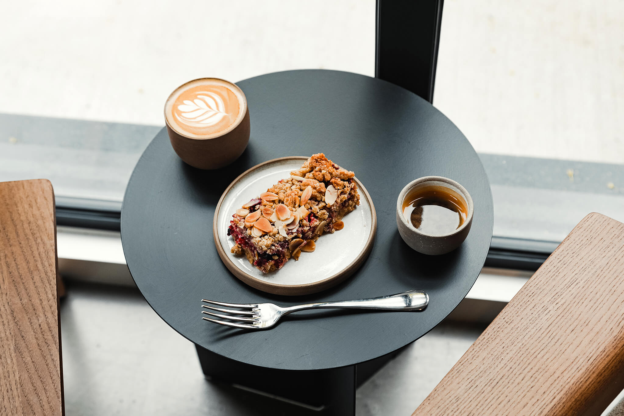 A pair of coffee ceramics on a table with some cake