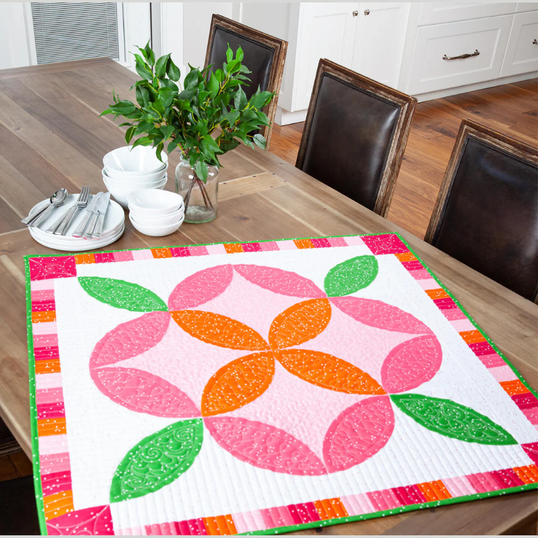 A colorful Melissa Mortenson table topper qiult kit.