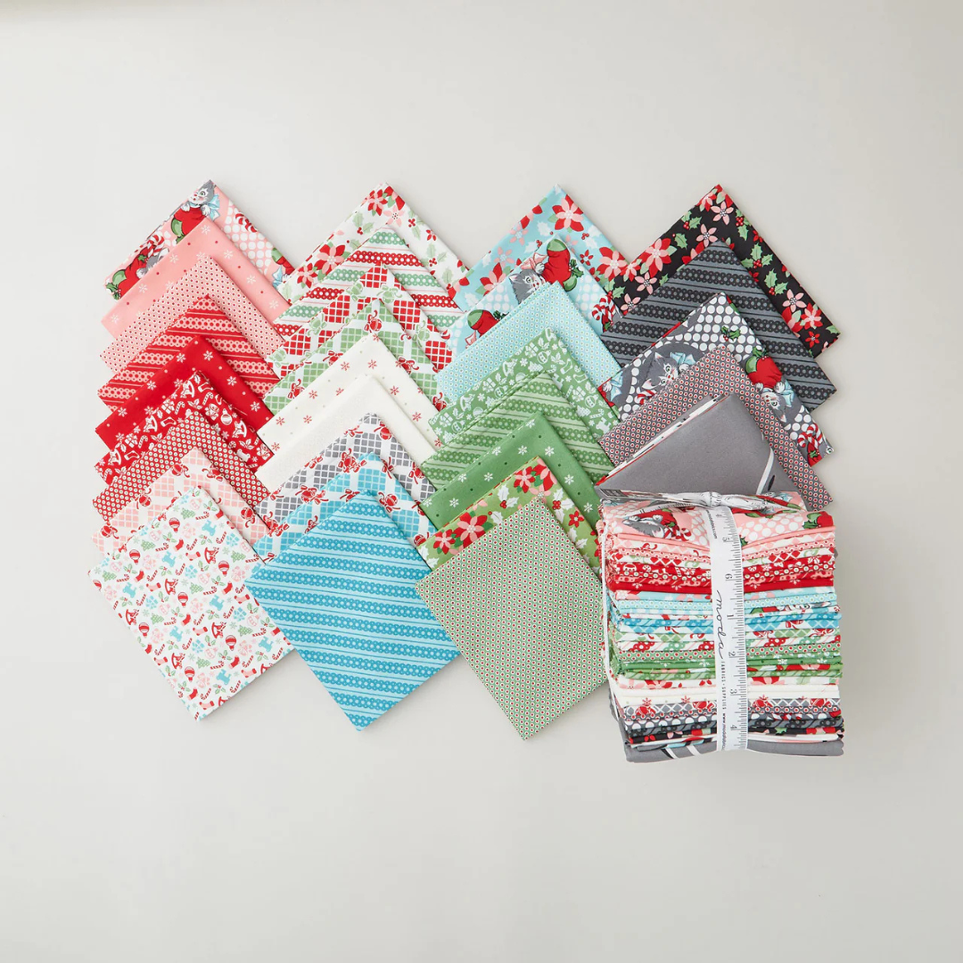 a selection of fat quarter prints from the kitty christmas fabric collection by urban chiks.