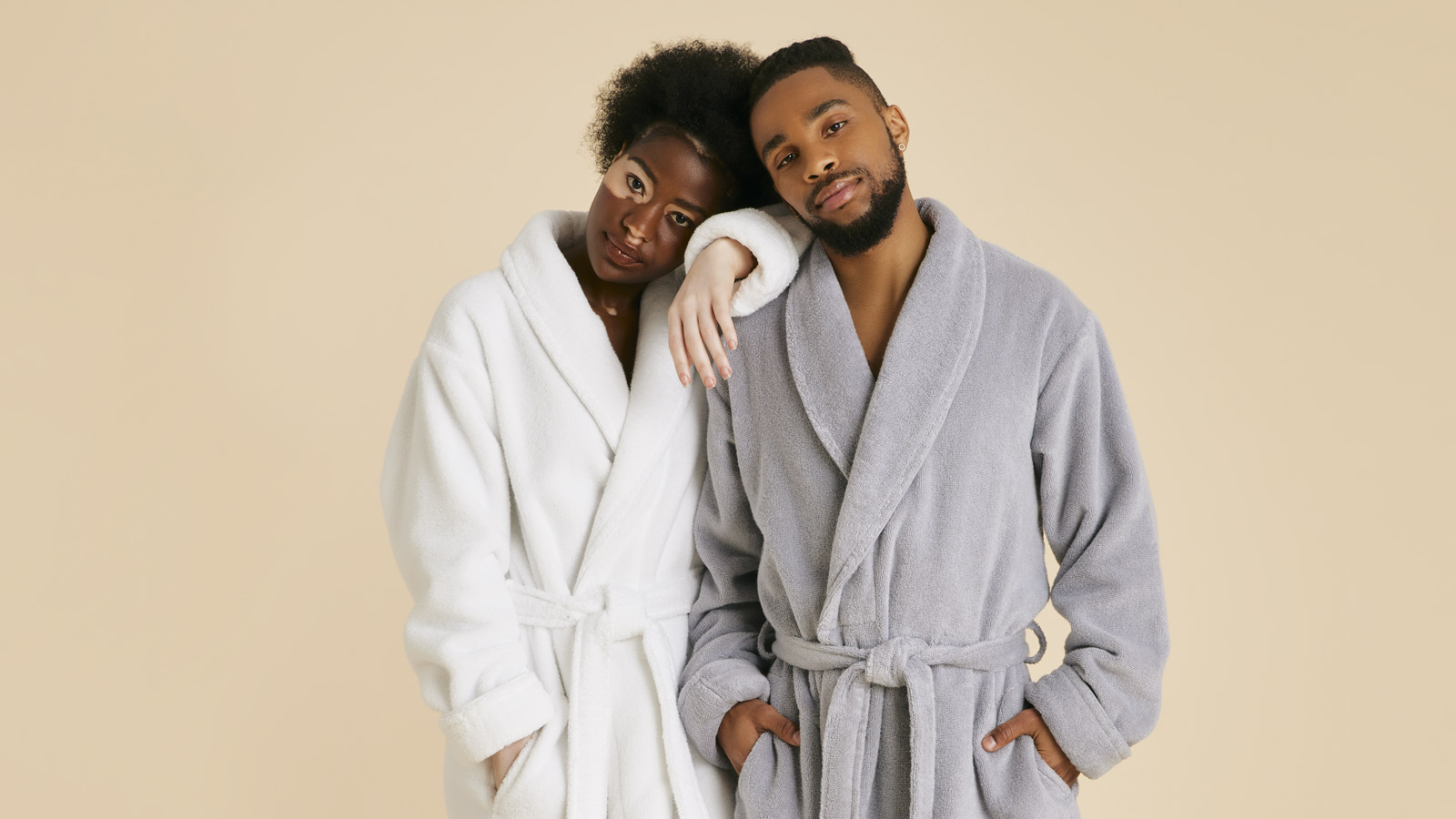 Man and woman wearing our Super-Plush robes in White and Smoke.