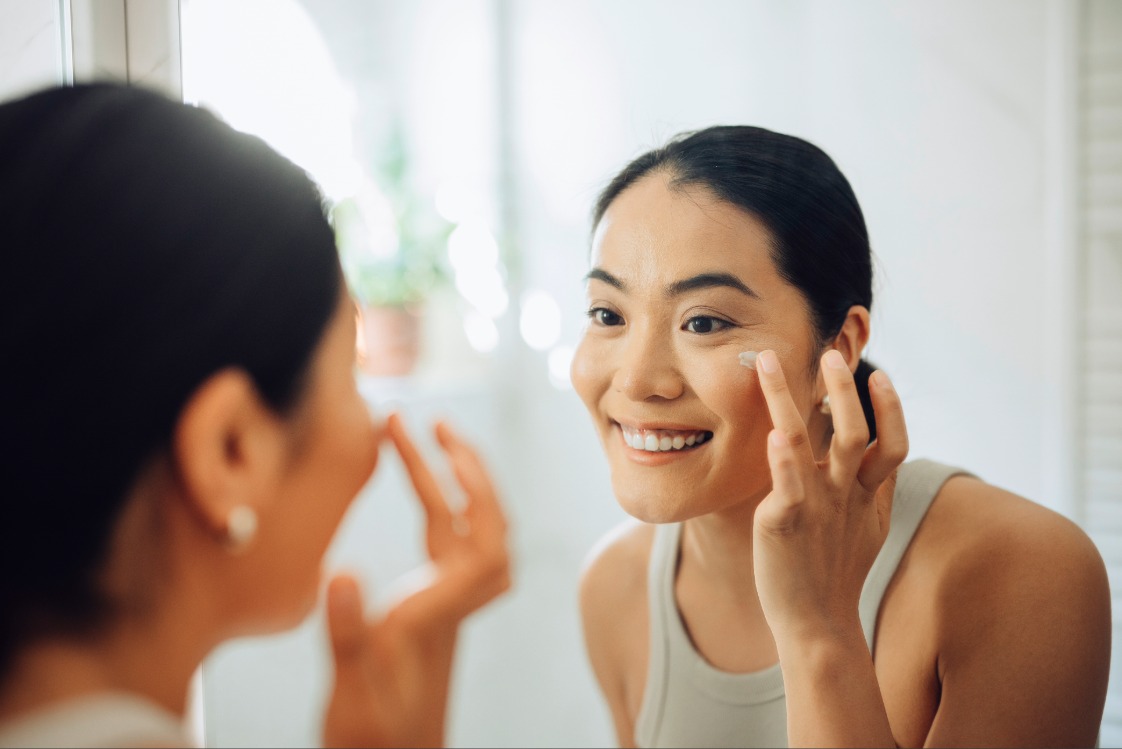 Person looking in a bathroom mirror
