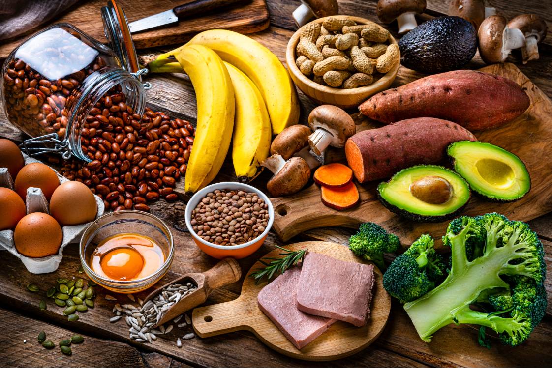 Food assortment rich in biotin including eggs, bananas, nuts, and vegetables