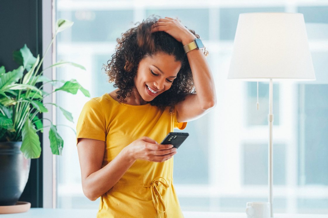 Person checking a smartphone in a bright indoor setting