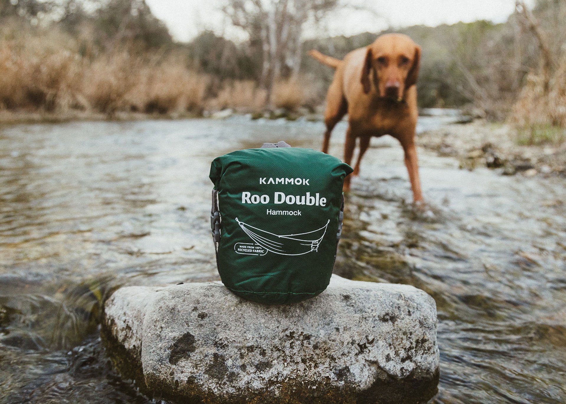 Kammok Roo Double, two person hammock, in water-resistant rolltop stuff sack on a rock in the river.