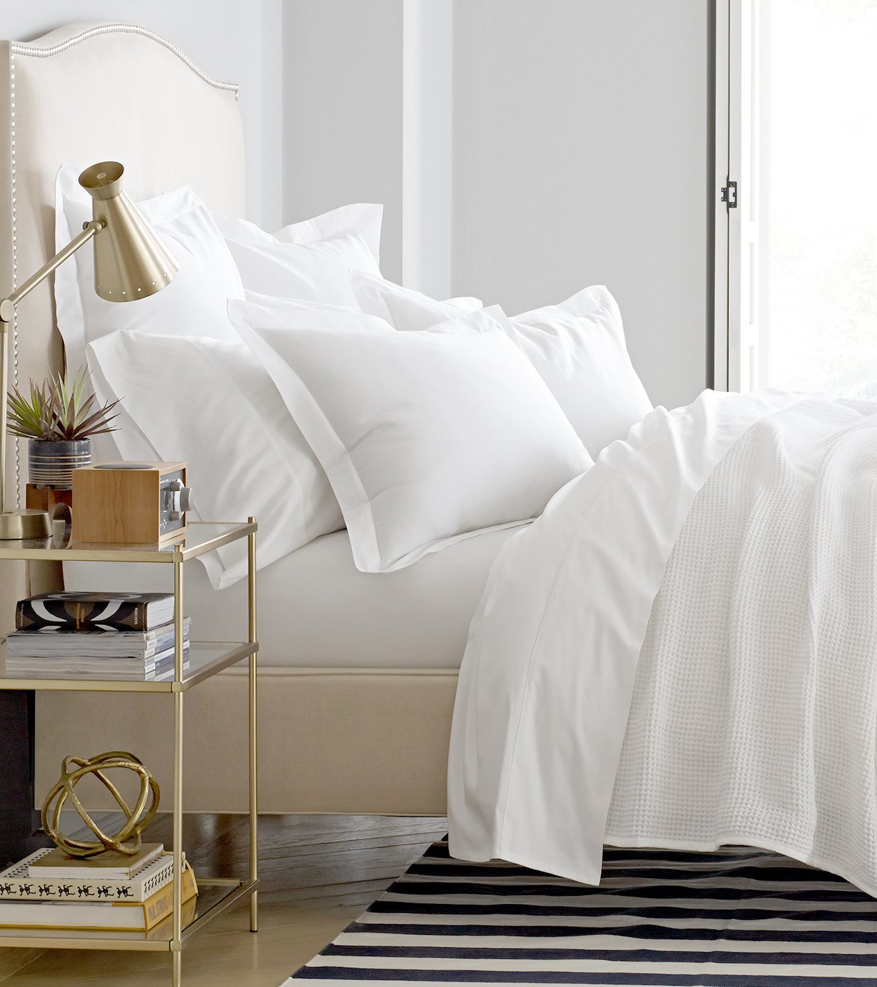 Side profile bed with white sheets