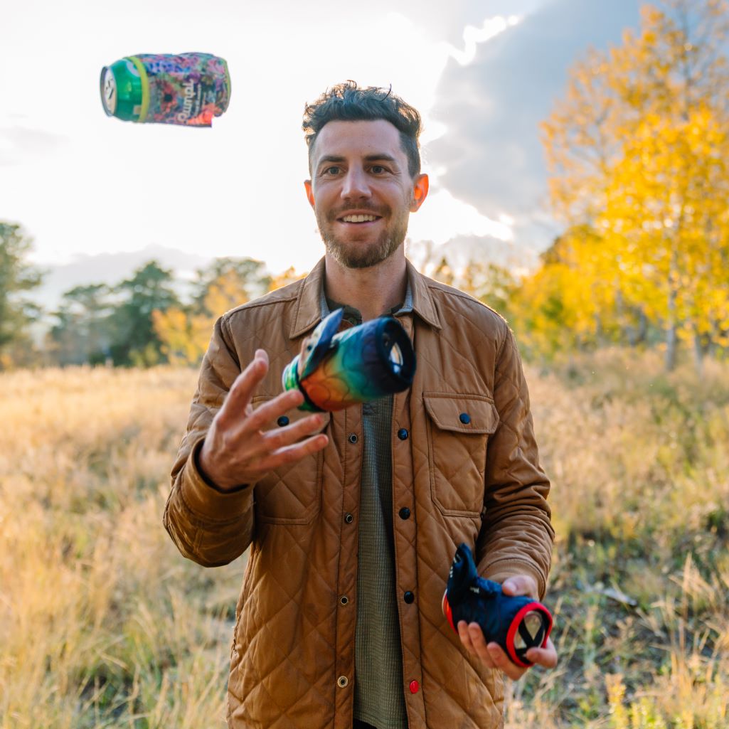 A man tosses a few beers covered in Rumpl beer blankets