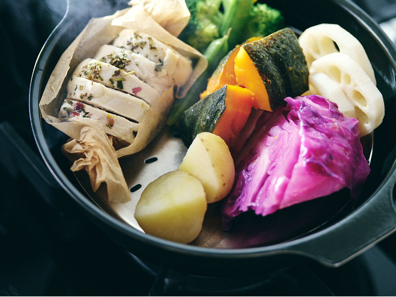  A meal steaming in a KAKOMI Caeramic Pot on a Steam Plate 