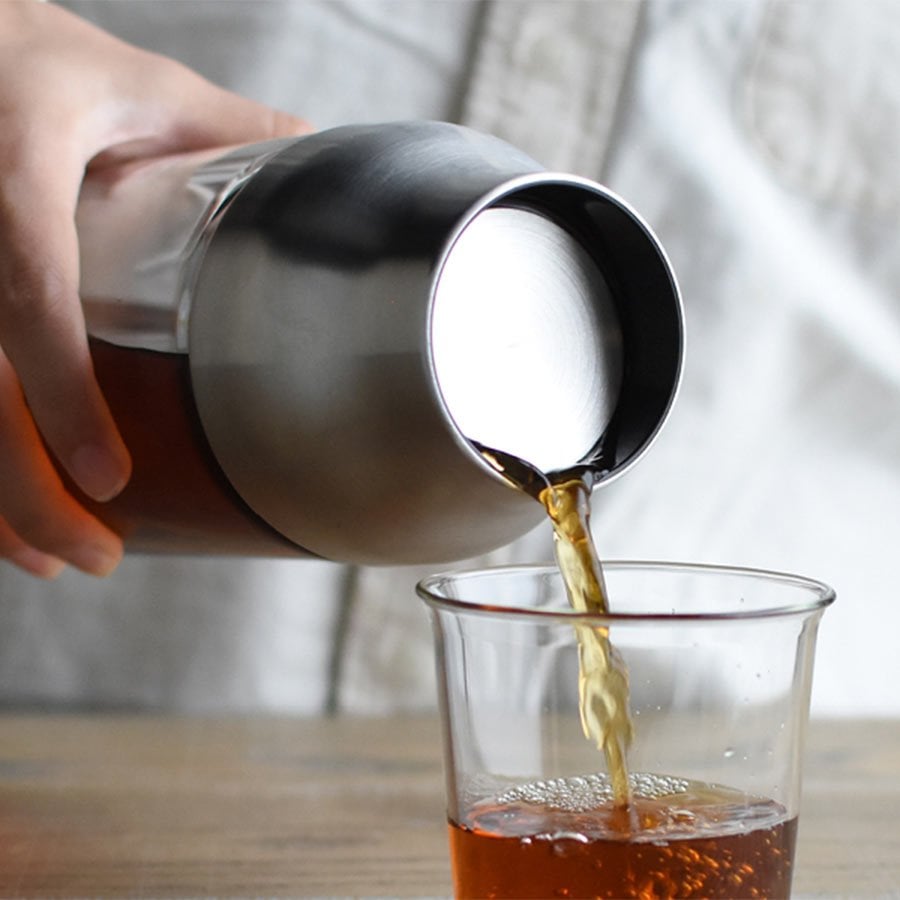  CAPSULE cold brew carafe pouring coffee into CAST green tea cup  
