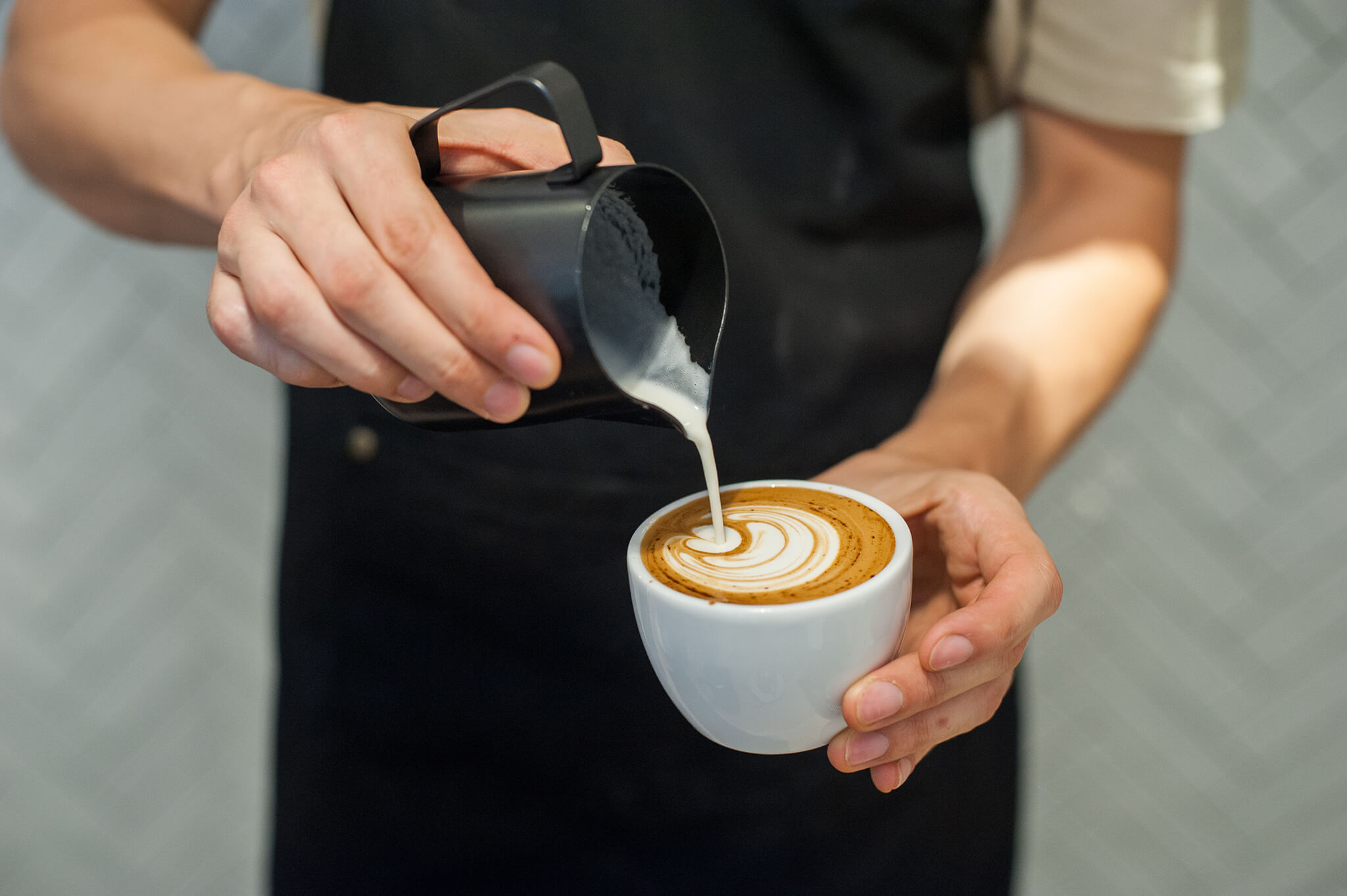 Latte art being poured at a coffee making class