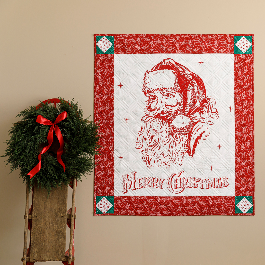 Quilted wall hanging features a vintage Santa in red and white with 