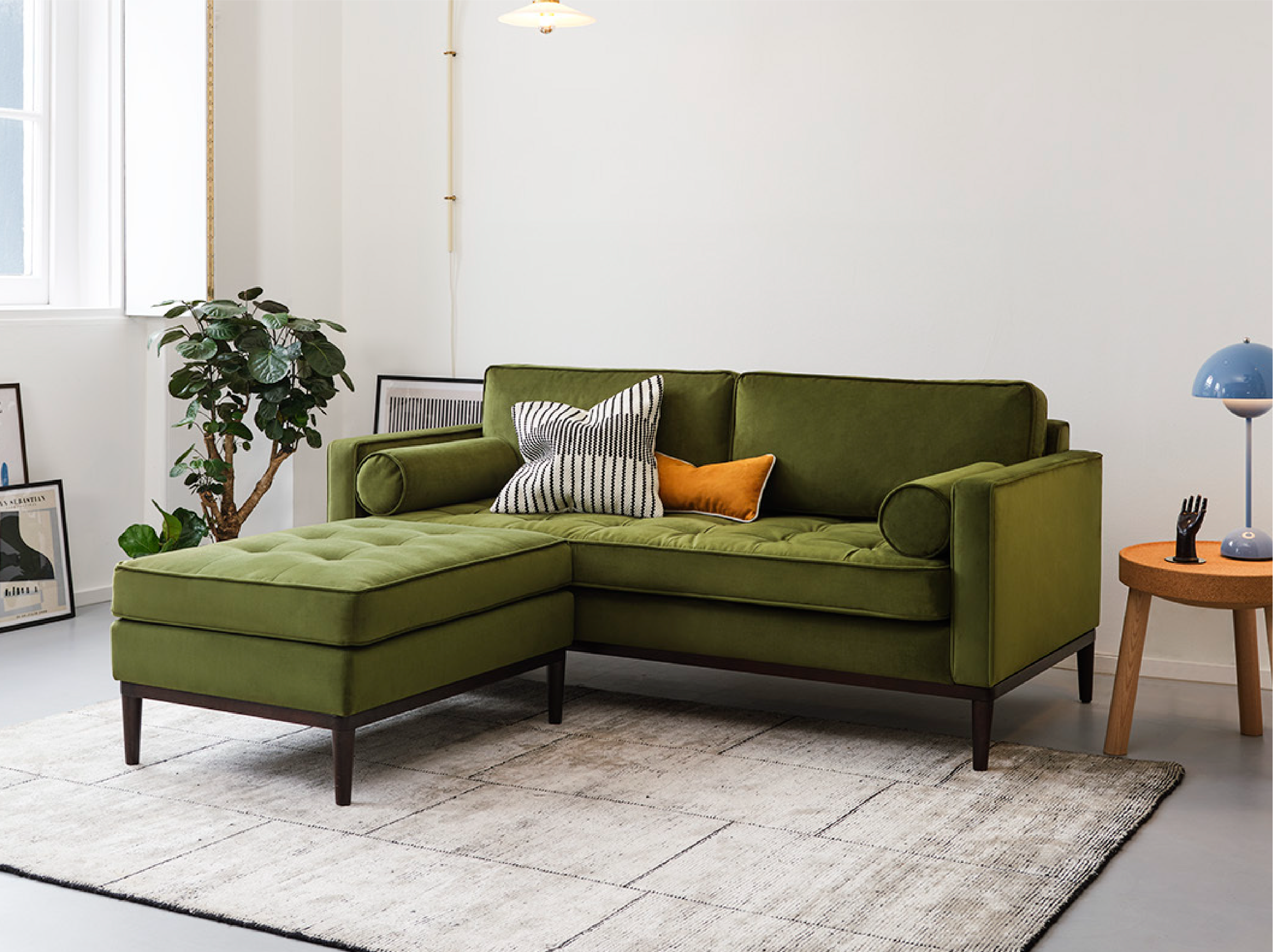 Velvet upholstered ottoman with matching green sofa