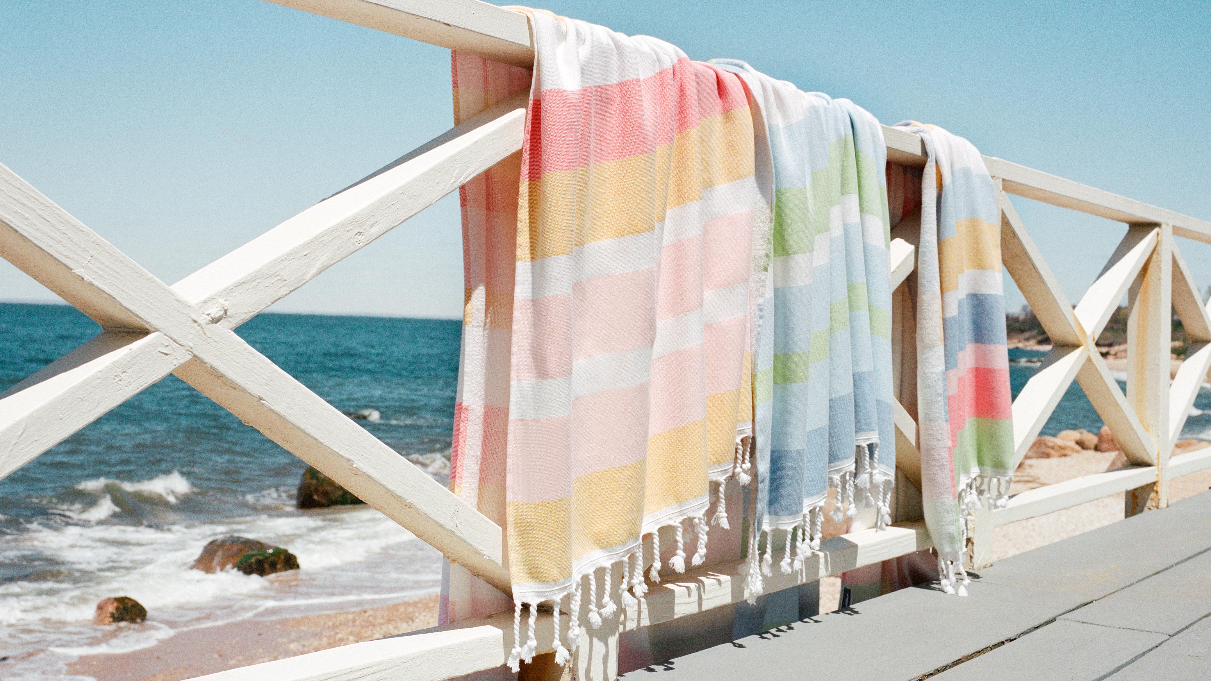Beautiful beach scene featuring our latest Hammam towel collection, perfect for the beach, pool, and beyond.