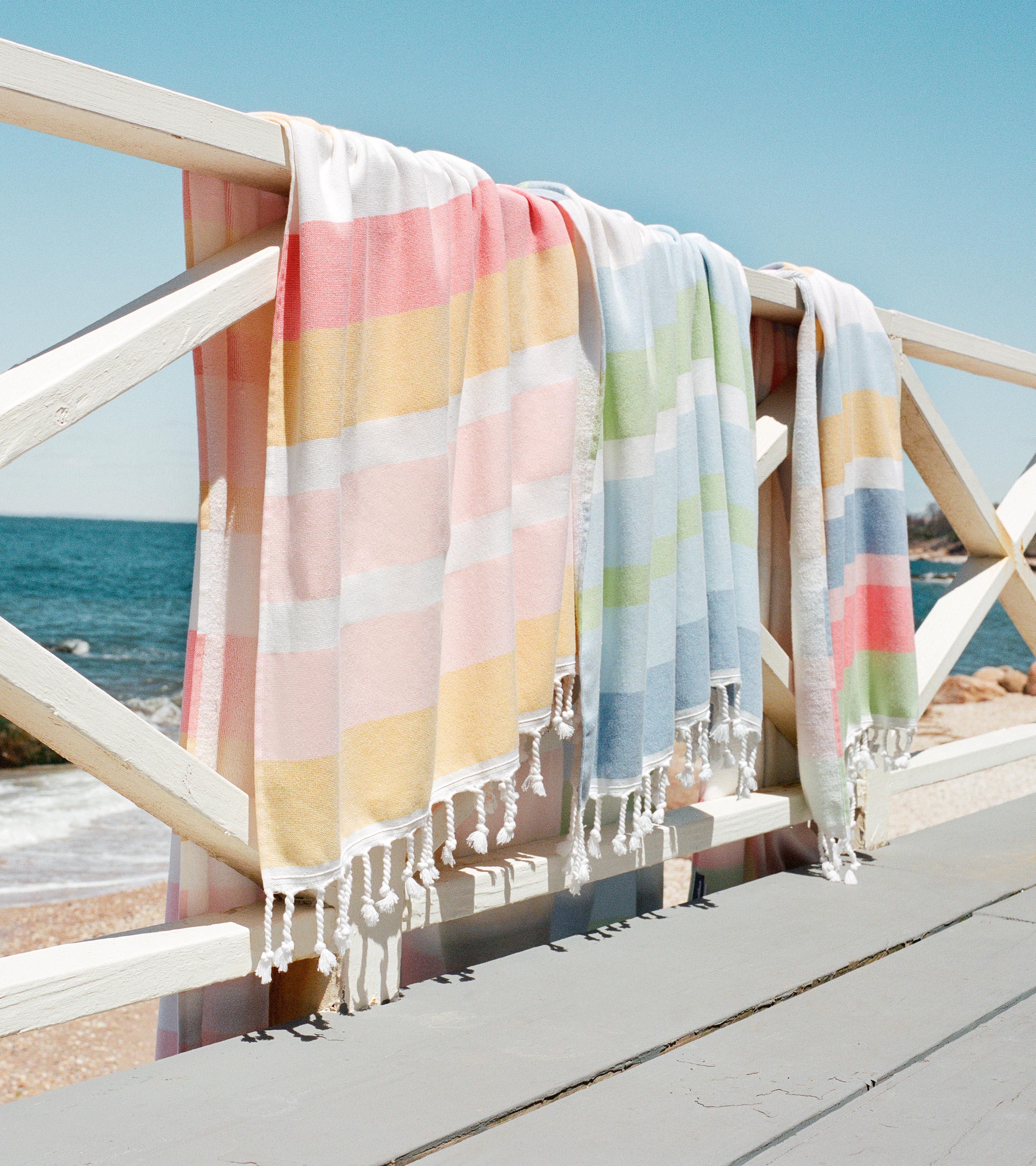 Beautiful beach scene featuring our latest Hammam towel collection, perfect for the beach, pool, and beyond.