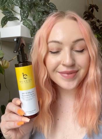 Woman reviewing Beauty By Earth's Sunscreen
