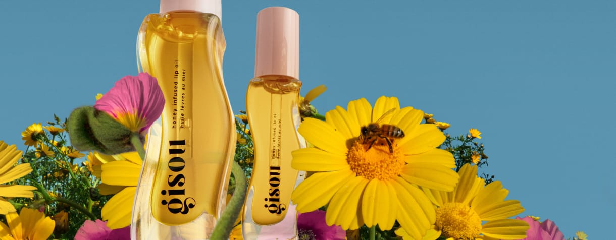Honey Infused Lip Oil in a field of daisies