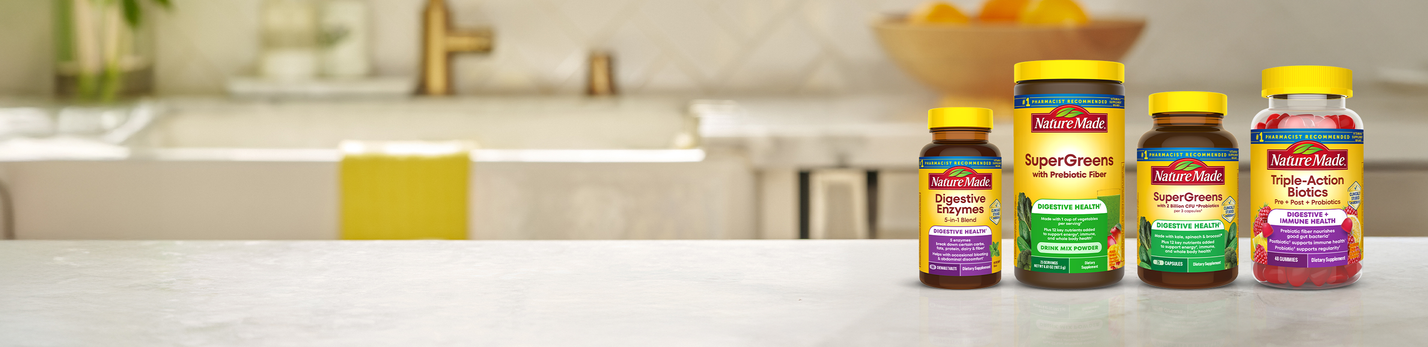 Nature Made digestive health supplements including SuperGreens, Digestive Enzymes, and Triple‑Action probiotics on a countertop.