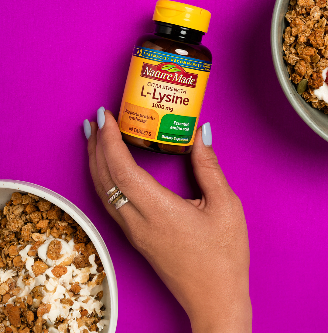 Nature Made® L-Lysine next to a bowl of granola