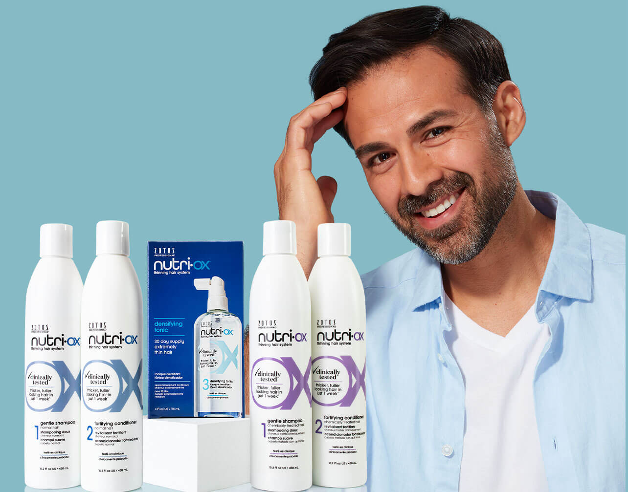 male model with hair product bottles on blue background