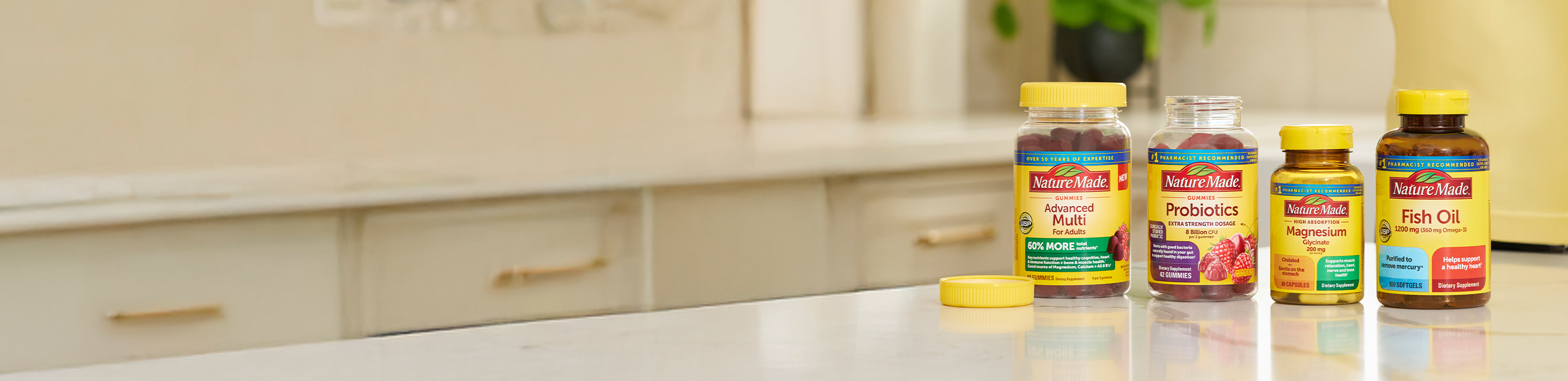 Nature Made Advanced Multi, Probiotics, Magnesium, and Fish Oil displayed on a kitchen counter. 