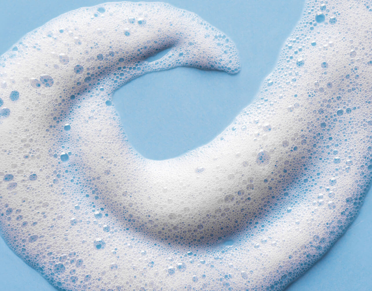 bubbly hair care product on blue background