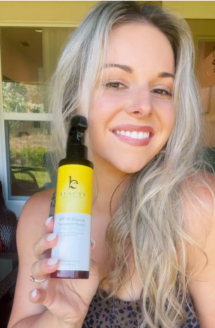 Woman using Beauty By Earth Mineral Sunscreen Spray