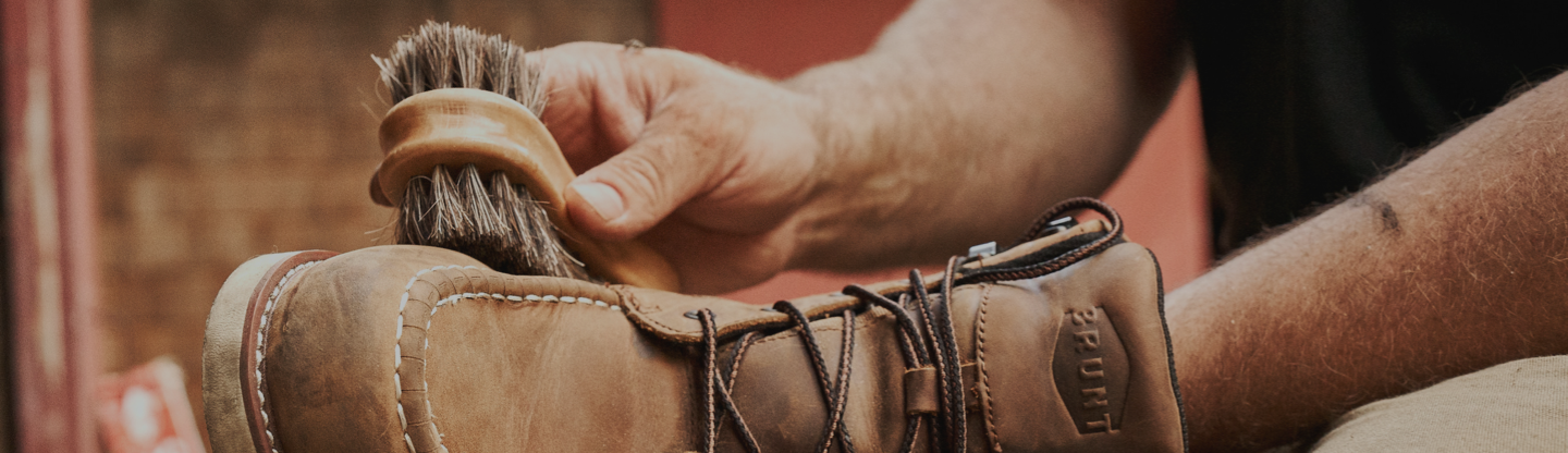 Man applying BRUNT leather conditioner to Marin Work Boot using Horse Hair Brush