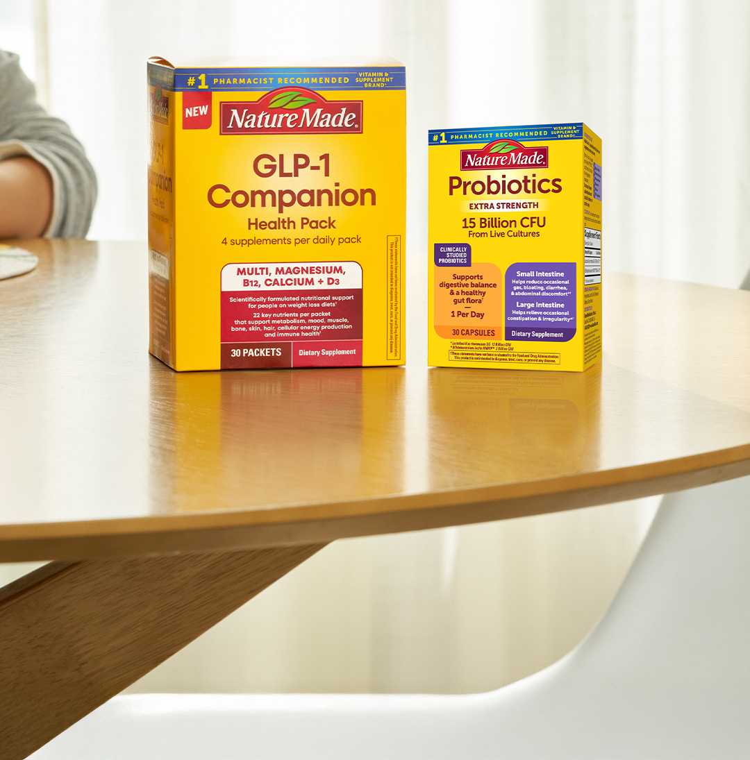 Nature Made GLP-1 Companion Health Pack and Probiotics Extra Strength boxes on a wooden table.