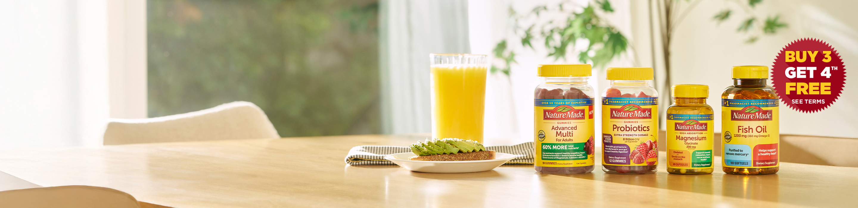Nature Made vitamins and supplements on a kitchen table with orange juice and avocado toast, featuring Advanced Multi, Probiotics, Magnesium, and Fish Oil bottles with a Buy 3 Get 4 Free offer.