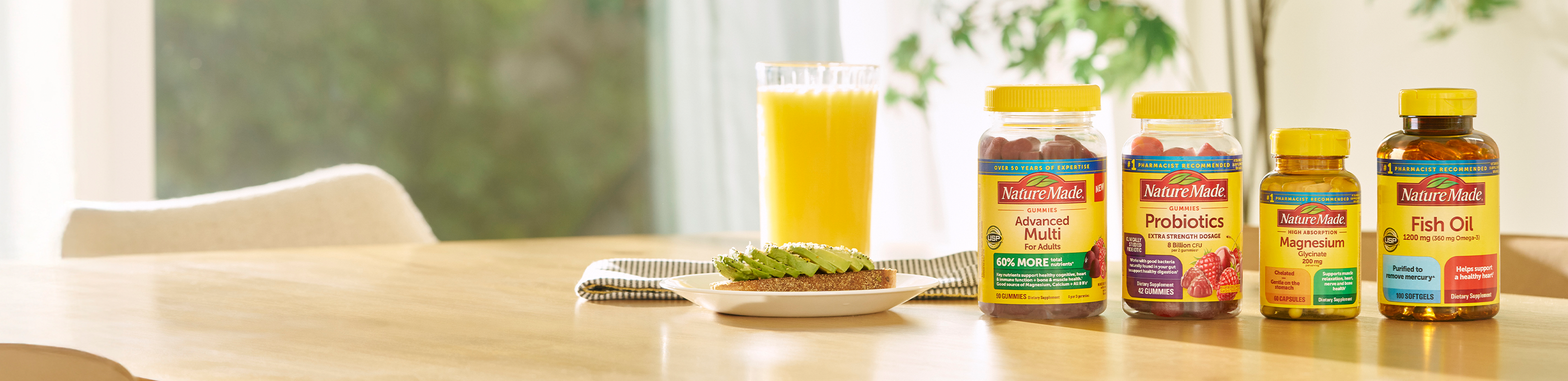 Nature Made Daily 4 supplements—multivitamin, probiotics, magnesium, and fish oil—displayed on a kitchen table beside avocado toast and orange juice.